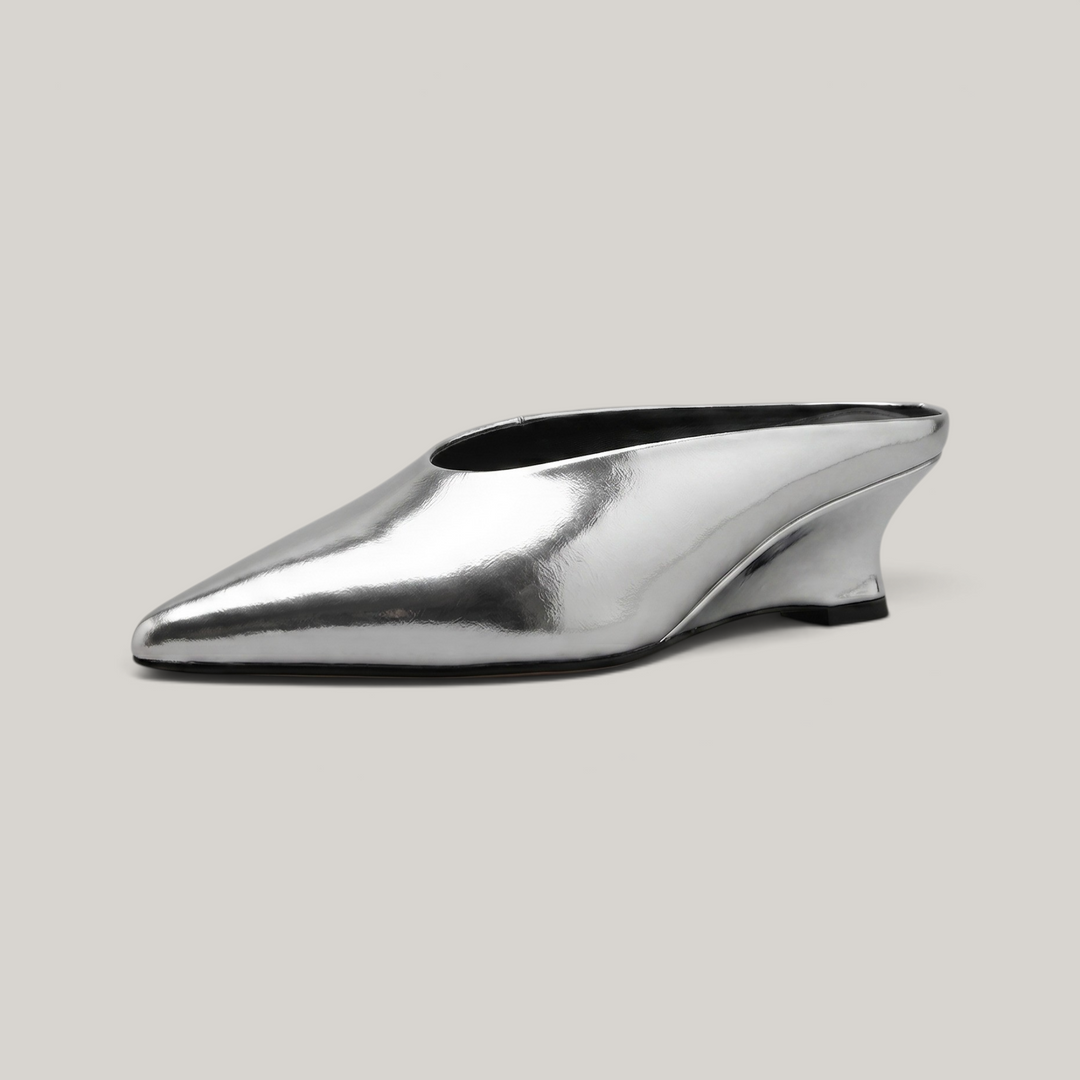 USS® Shoes Lumière mule in metallic silver leather with a sharp pointed toe and architectural kitten heel.