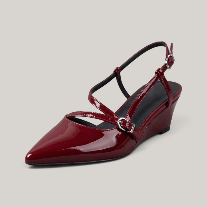 USS® Shoes Valeria wine-red patent leather slingback heels with a pointed toe, low wedge, and gold buckle straps.