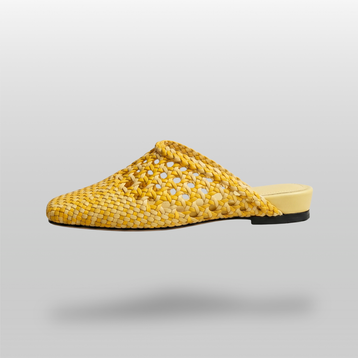 Side profile of the USS Sienna Mule in yellow leather, showcasing the ultra-slim sole and breathable artisanal woven pattern.