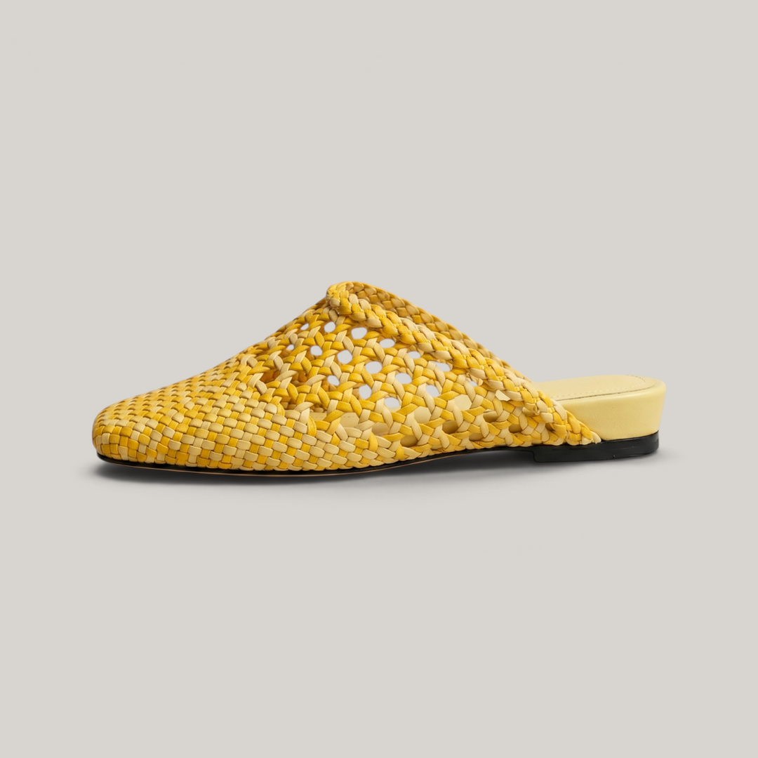 Side profile of the USS Sienna Mule in yellow leather, showcasing the ultra-slim sole and breathable artisanal woven pattern.