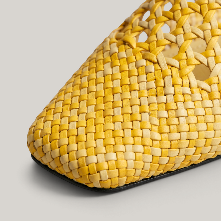 Extreme close-up of the hand-woven leather texture on the USS Sienna Mule, showcasing the square toe and artisanal craftsmanship.