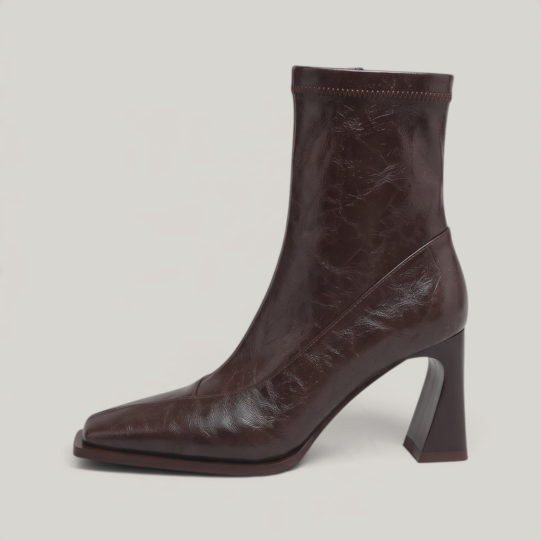 Side view of the Vienne Bootie in Moka Ciré, showing the flared heel and diagonal seam panel