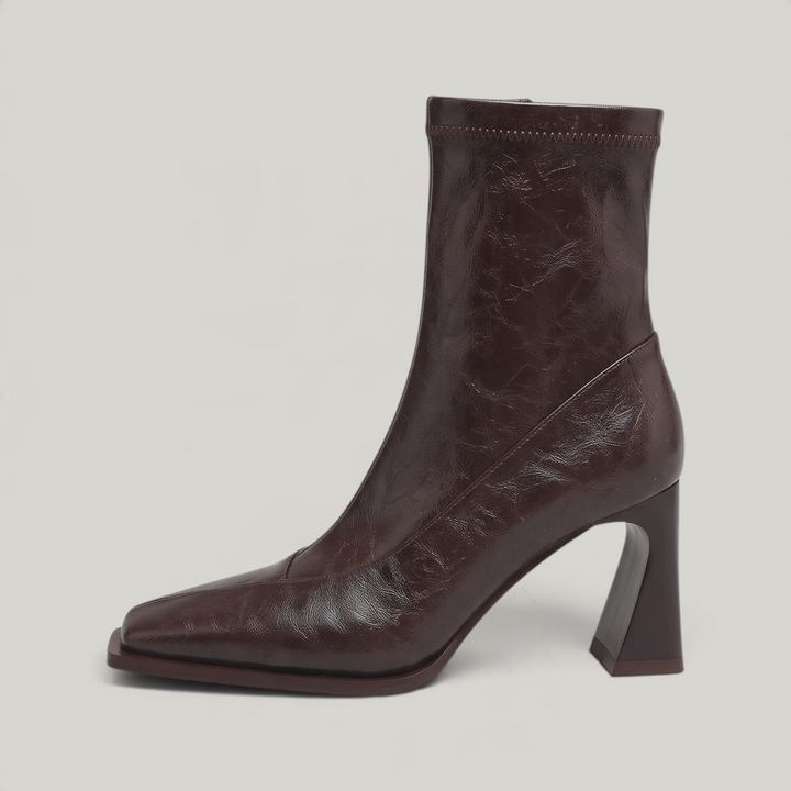 Side view of the Vienne Bootie in Moka Ciré, showing the flared heel and diagonal seam panel