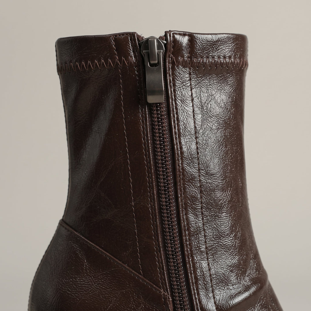 Inside zip with gunmetal pull on the stretch ankle shaft of the Vienne Bootie in Moka Ciré