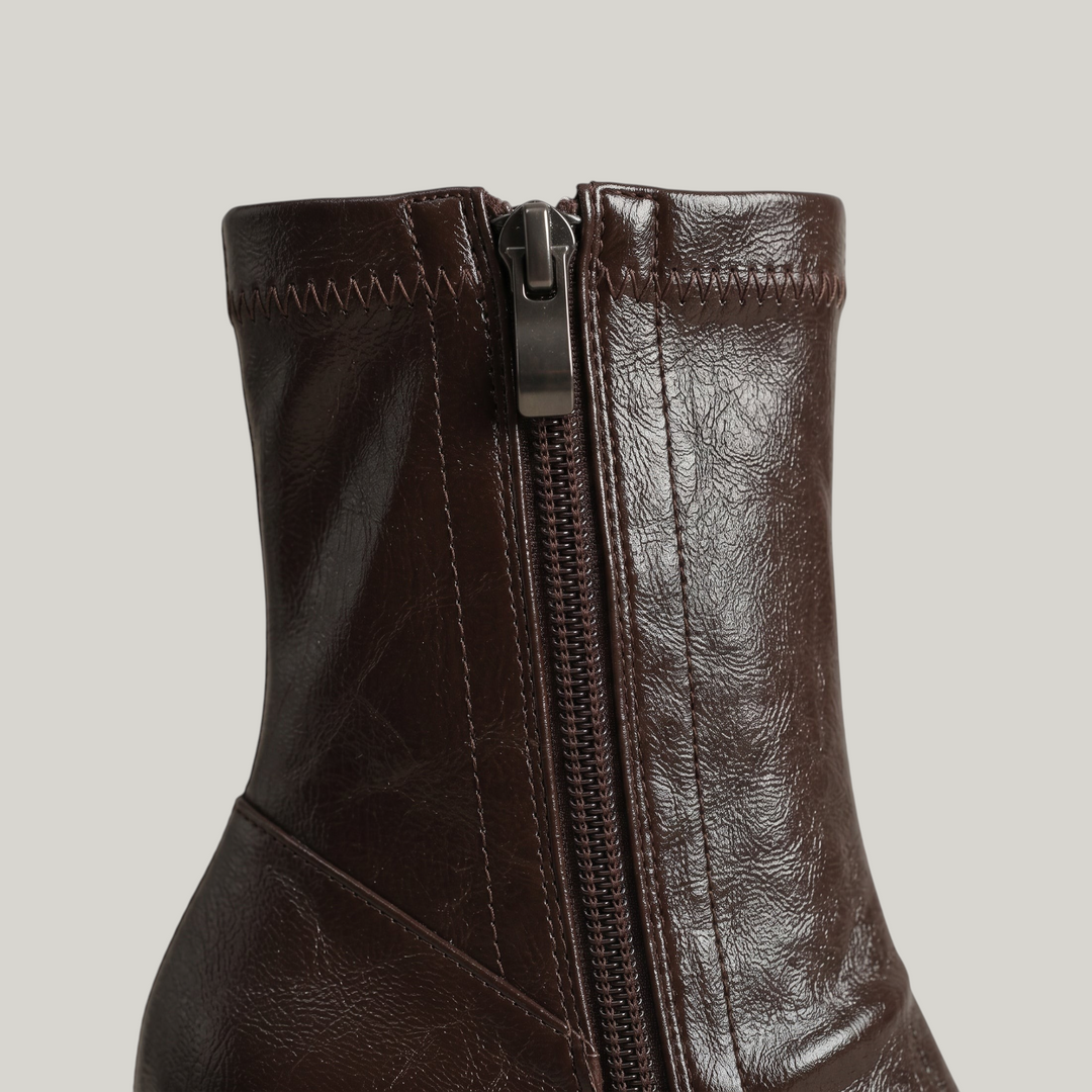 Inside zip with gunmetal pull on the stretch ankle shaft of the Vienne Bootie in Moka Ciré