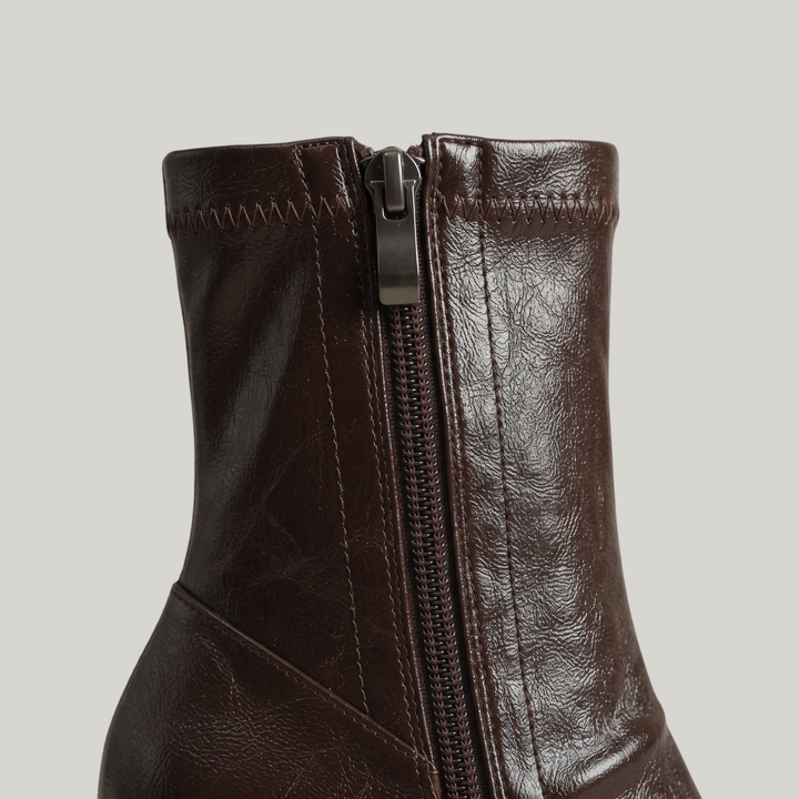 Inside zip with gunmetal pull on the stretch ankle shaft of the Vienne Bootie in Moka Ciré